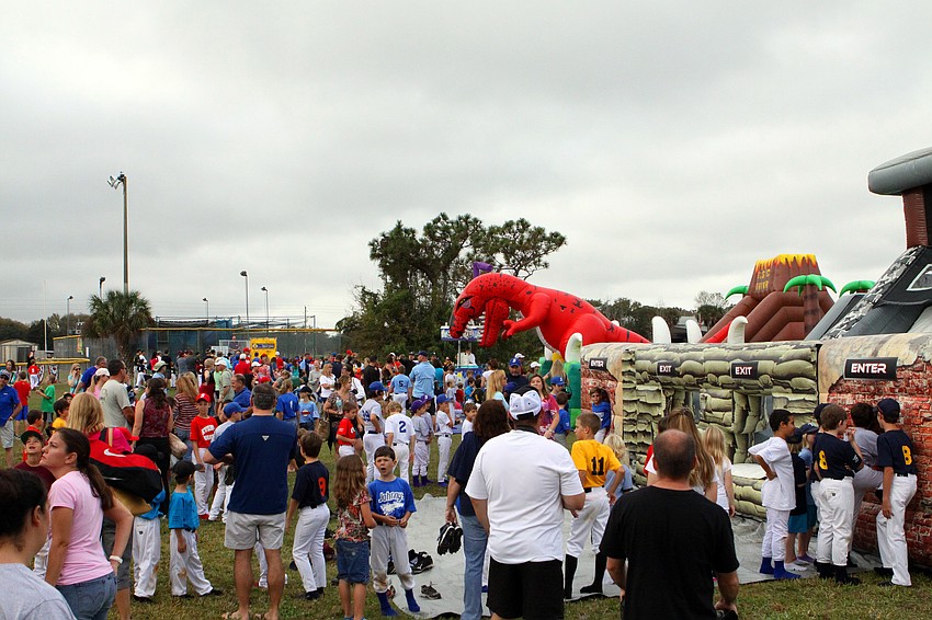 Following the opening day ceremony, families had fun playing on inflatable slides and enjoying snow cones.