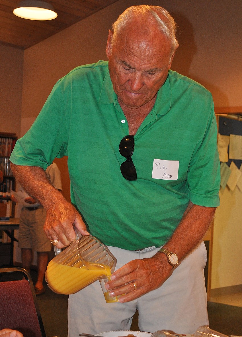 Bob Mau serves up some orange juice at one of the tables, Tuesday, Feb. 28, during the Siesta Key Chapel's Men's Fellowship breakfast in the Fellowship Hall.
