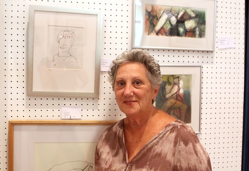 Lila Gibbs, the chairwoman of the art show, with one of her pieces entitled 