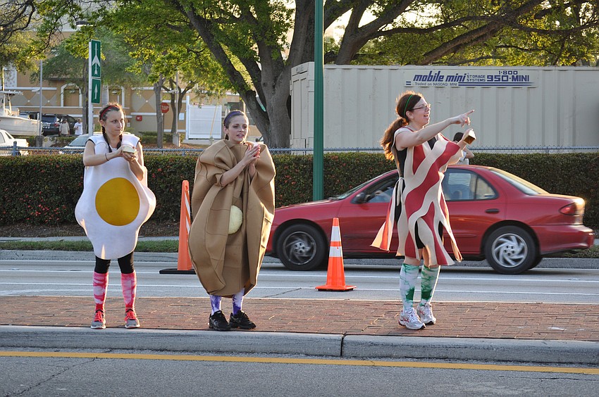 Hannah Hrobos, Danielle Hostings and Kim Knox cheered on runners dressed as breakfast foods.