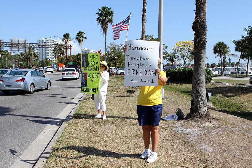 Protestors from various Conservative groups in Sarasota and Manatee counties hold up signs about President Obama, the 1st Amendment, and religious reform.