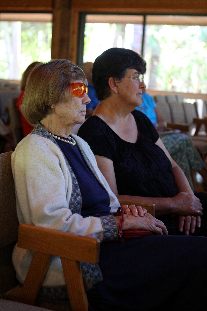 Elanor Dunham and Beverley Underwood watch Dr. Zachary Johnson perform.
