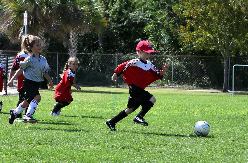 William Hall, 5, gets the ball and makes his way towards the other end of the field.