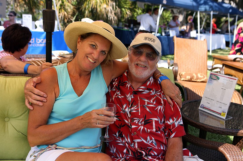 Susan and Richard Vincent enjoy sitting on some comfy outdoor lounge furniture in the shade of an umbrella.