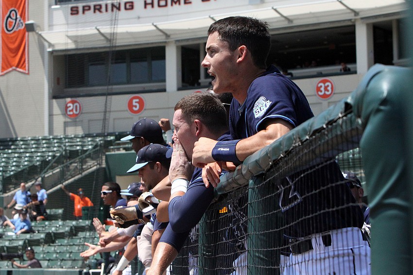 The SCF Manatees cheer their teammates on base and at bat, Tuesday, April 3, at Ed Smith Stadium.
