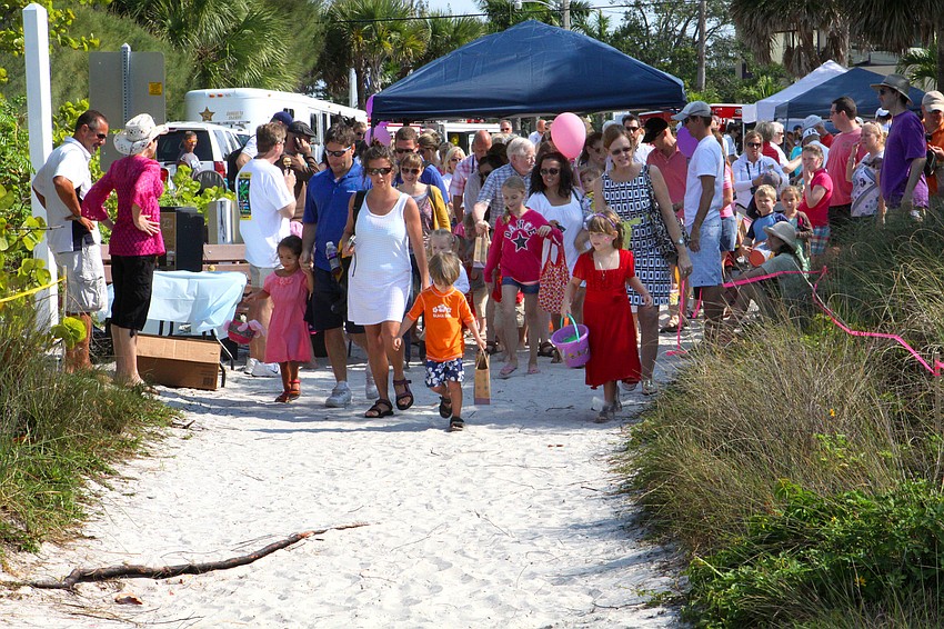 Parents and kids leave the starting line and head out to collect eggs.