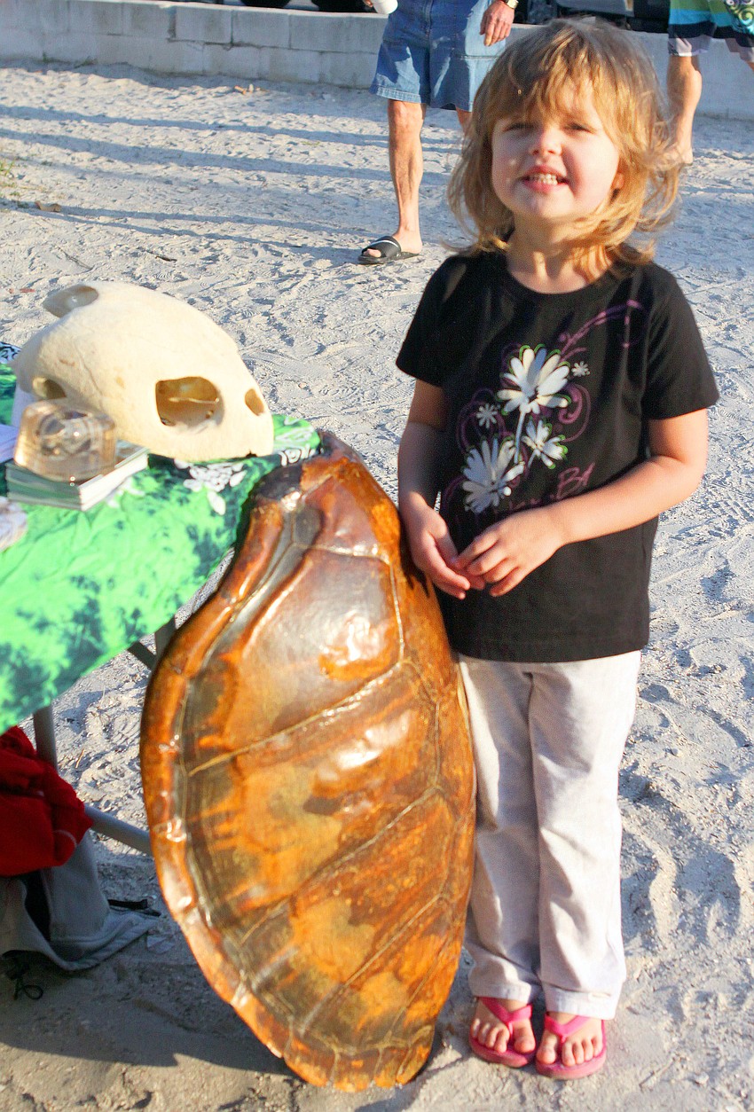 Melanie Kersten, 4, checks out the turtle shell and skull at one of the information tables.