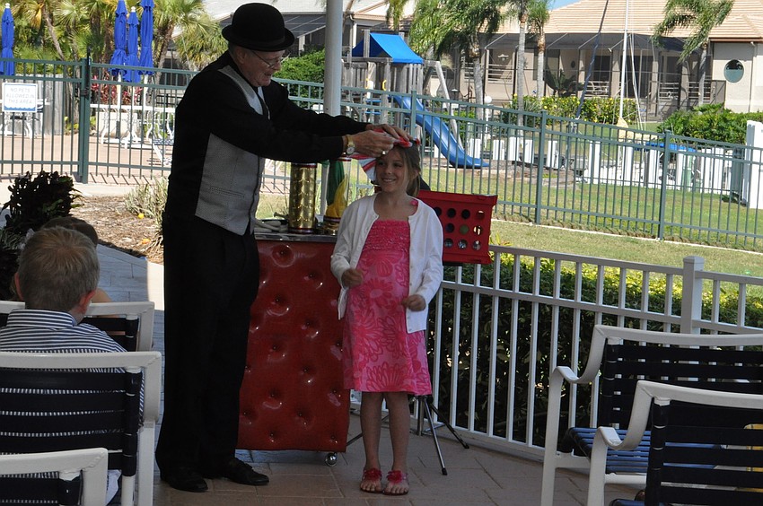 Stevie Dee the magician gives Jade Gallagher an Easter bonnet