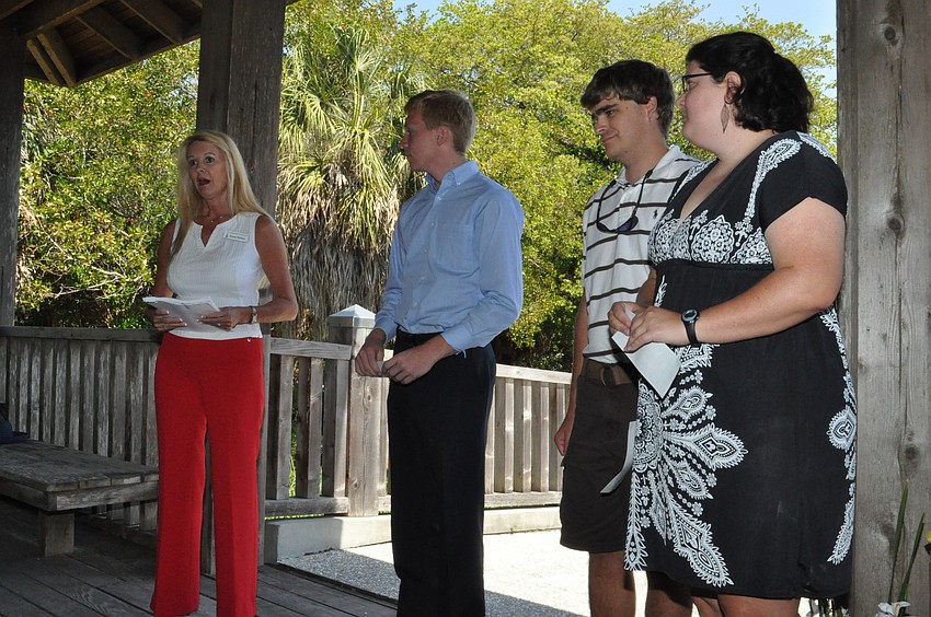 Susan Phillips awards college scholarships to three of the six recipients: Michael Thomas Long, Geoffrey Henry Smith and Amanda Claire Croteau