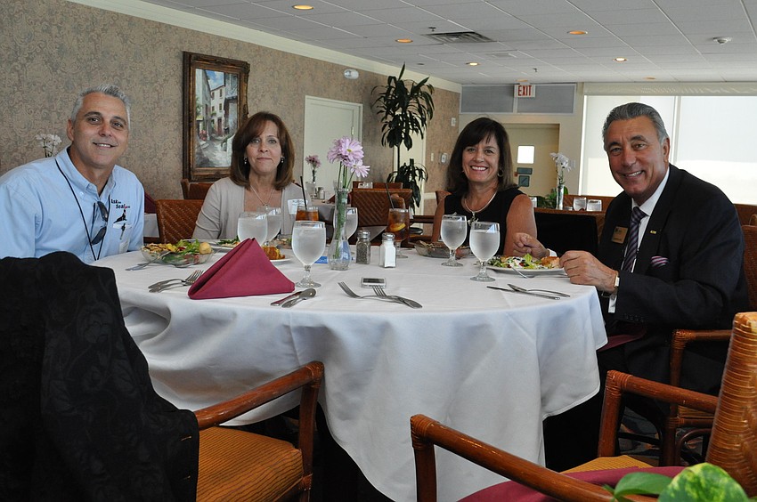 Ed Marchiselli with AskTheSeal.com, Robyn Marchiselli with AskTheSeal.com, Allie Hueter with Florida Southern Roofing and GCSI Paintscape and President of the LLSA Chamber Andrew Vac