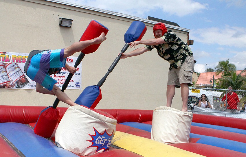 Curt Platte goes down after his brother knocks him off his post, Saturday, April 14, during the Siesta Gladiator Charity Challenge at SKOB