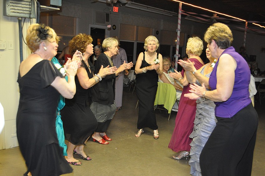 Women form a dancing circle at Twin Shores