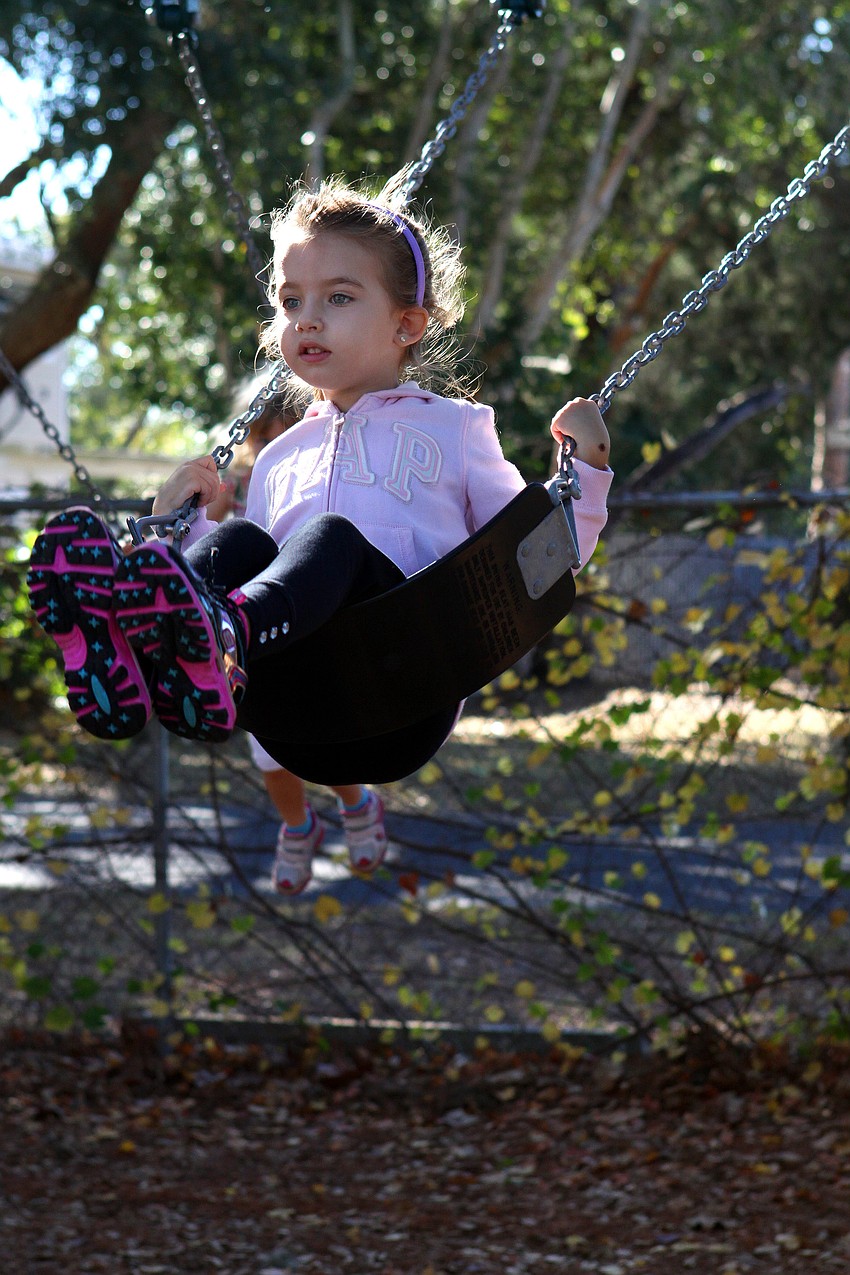 Victoria Mochovski, 4, enjoys swinging on the new swing set at Forty Carrots.