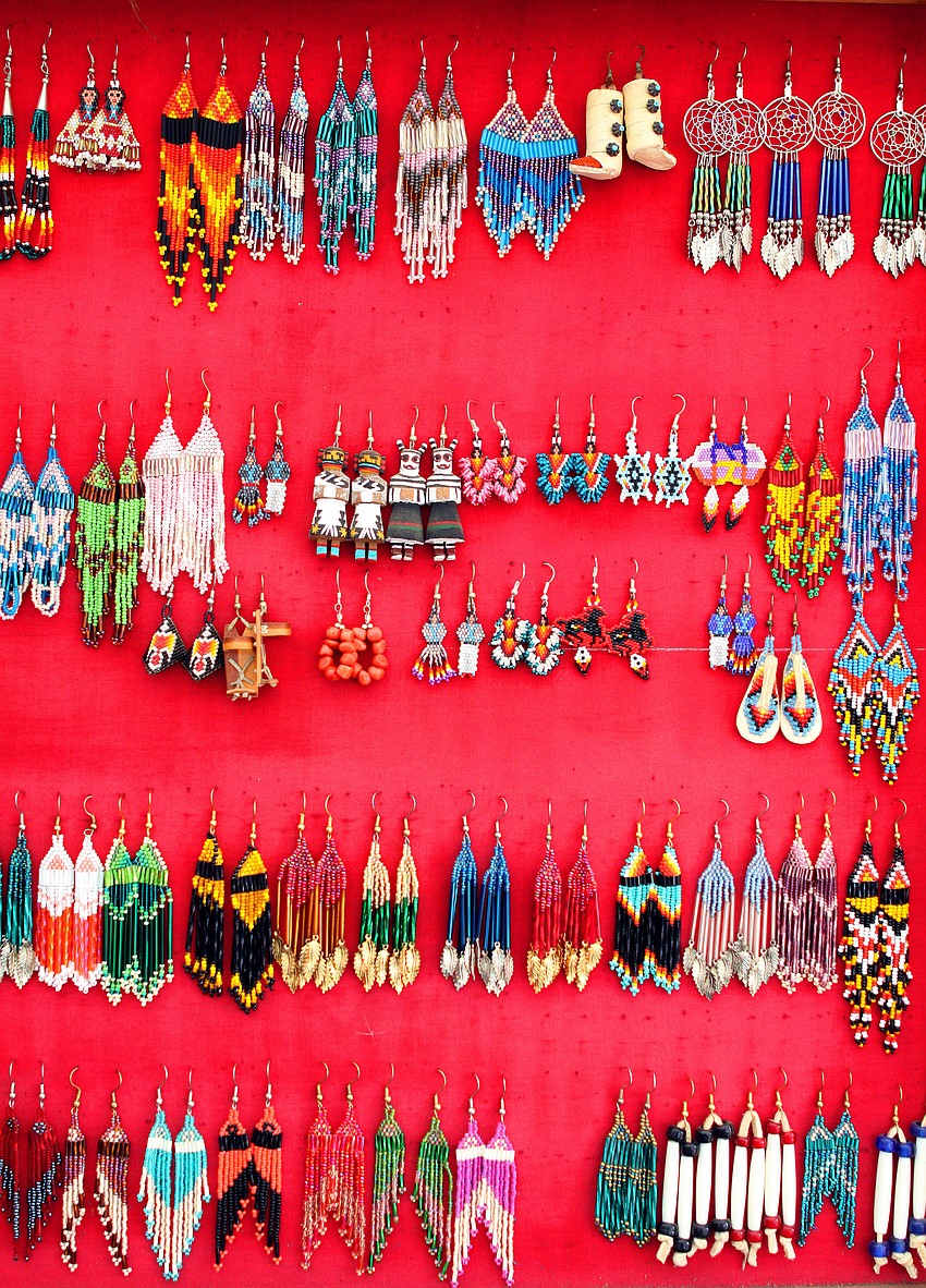 Beaded earrings hang on display inside Hawk's Nest tent at the Fifth Annual Sarasota Indian Festival.