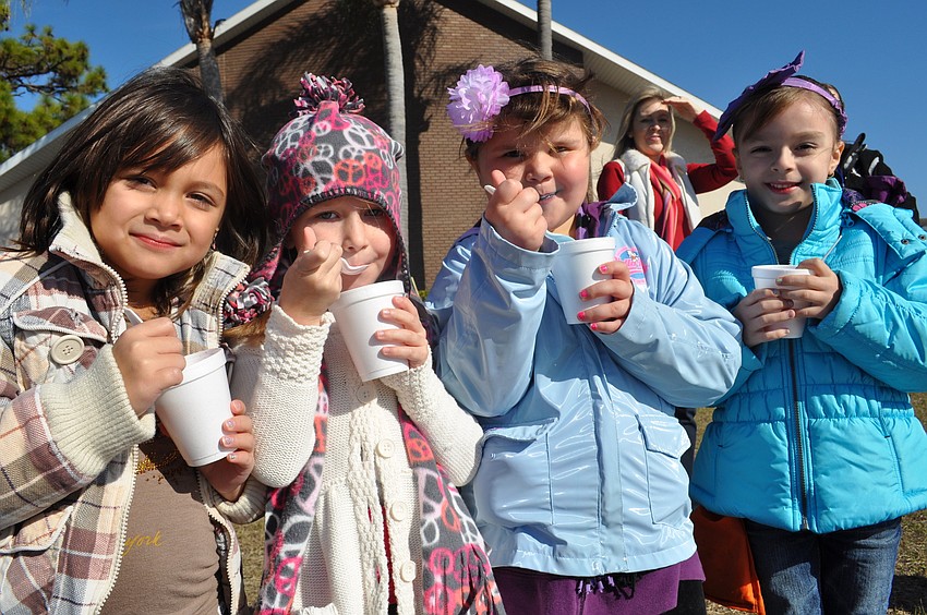 Students Alana Kutt, Kylee Pavkovich, Abby Mosher and Mariela Cheno enjoyed snow cones as they watched their friends sled.