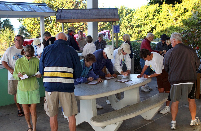 People sign up for the Senior Beach Walk inside the pavilion at Siesta Key Beach, Wednesday, Feb. 1.