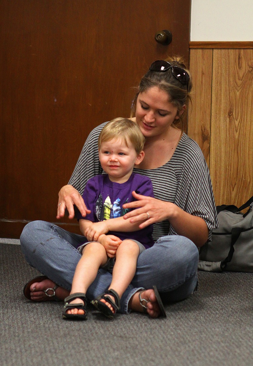 Jess Meetze does the sign for â€œclothesâ€ as Zachary Dutton, 23 mos., looks on, Tuesday, Feb. 7, during Baby Rhyme and Sign Time at Gulf Gate Library.