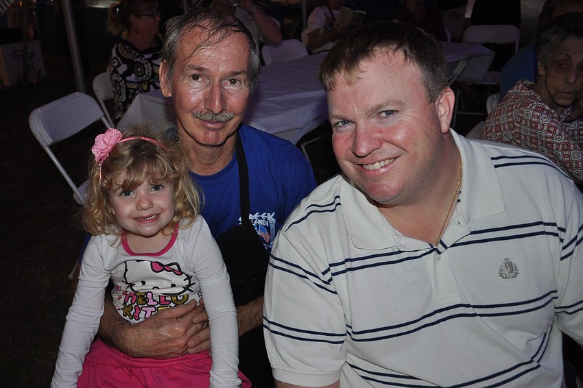 Paulina Whyte watched the dancers with her grandfather, Jim Ludera, and father, Matt Whyte.