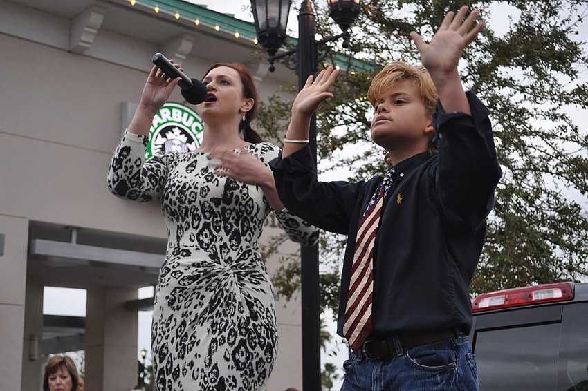 Meredith Garafalo sang the national anthem as Levi Waxler signed it.