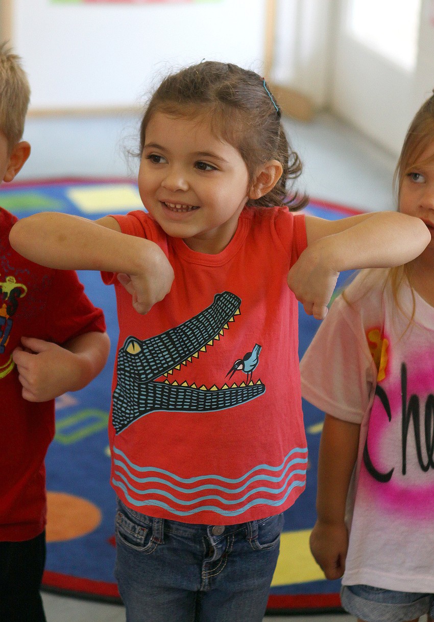 Helene Giraud, 3, does her impression of a monkey.