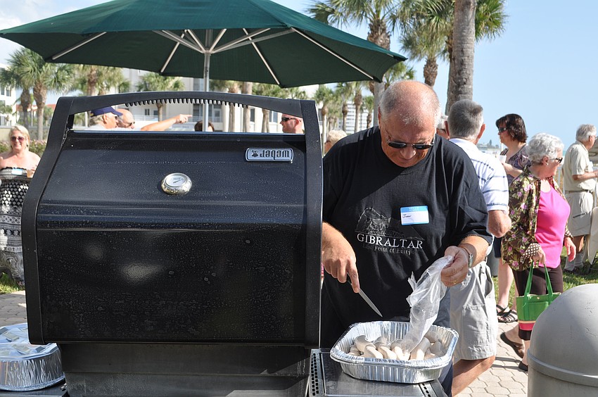 John Plaskon prepares the sausages.