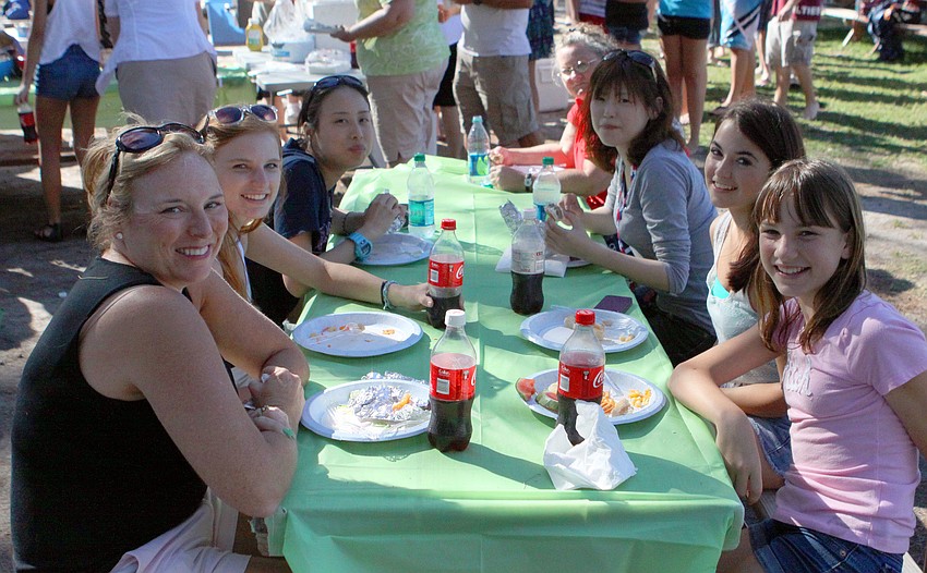 Tessa McKenna, Mattie McKenna, Yasuha Toki, Jduy Witham, Rieko Hayashi, Katherine Broussard and Elaina McKenna sit together during the Riverview Kiltie Band and Green Band picnic, Sunday, March 25.
