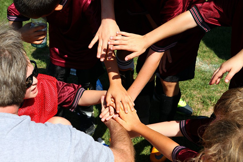 The LA Express teammates put their hands in before heading back out on the field.