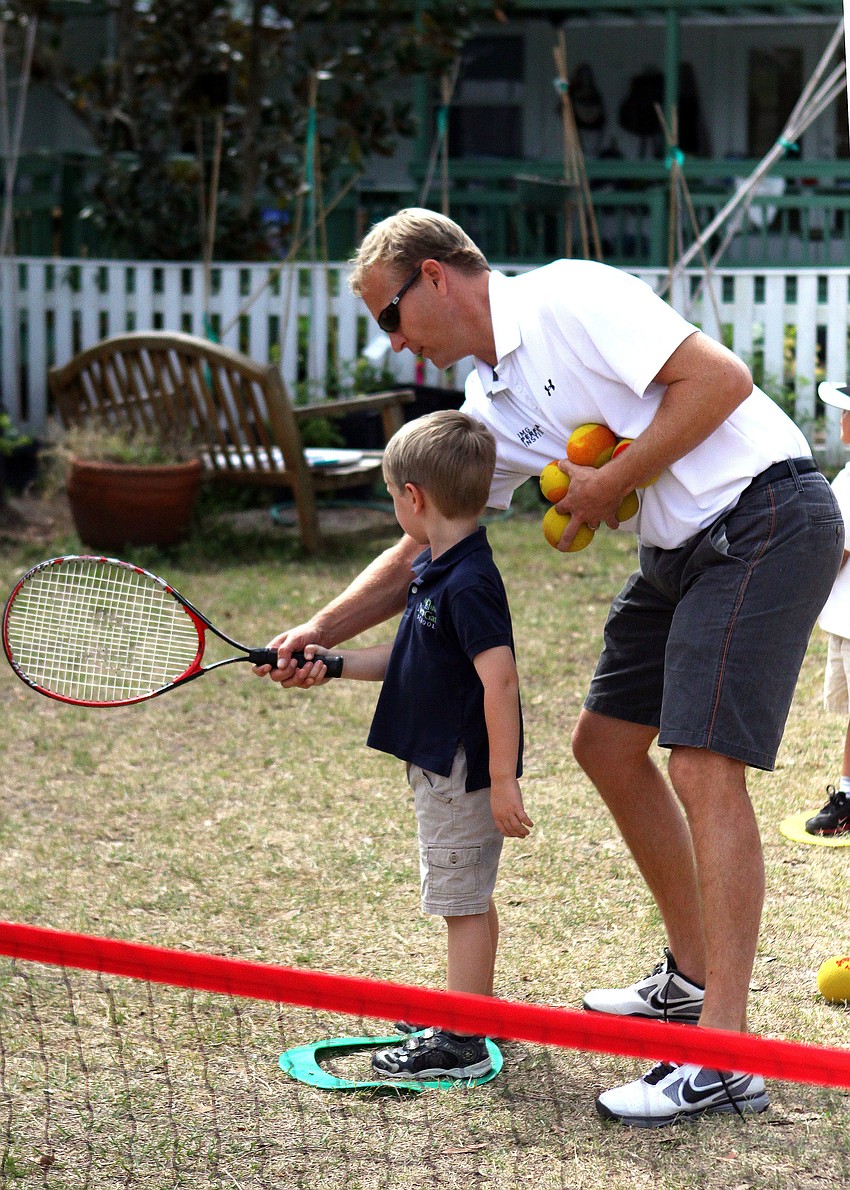 Sawyer Soboleski, 5, gets some pointers from Coach Scott Treibly during Tennis Tuesday at New Gate.