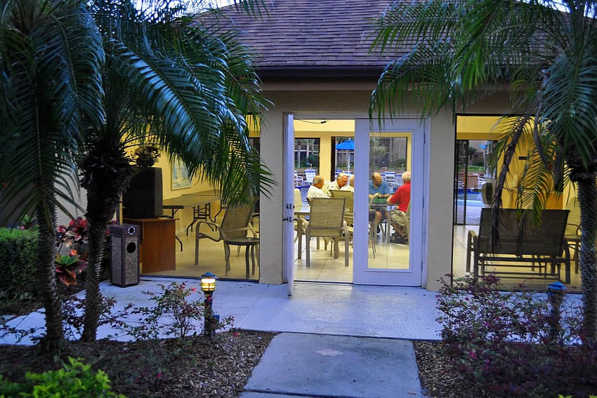 The men play inside the clubhouse by the pool at Midnight Cove II, Tuesday, March 27.