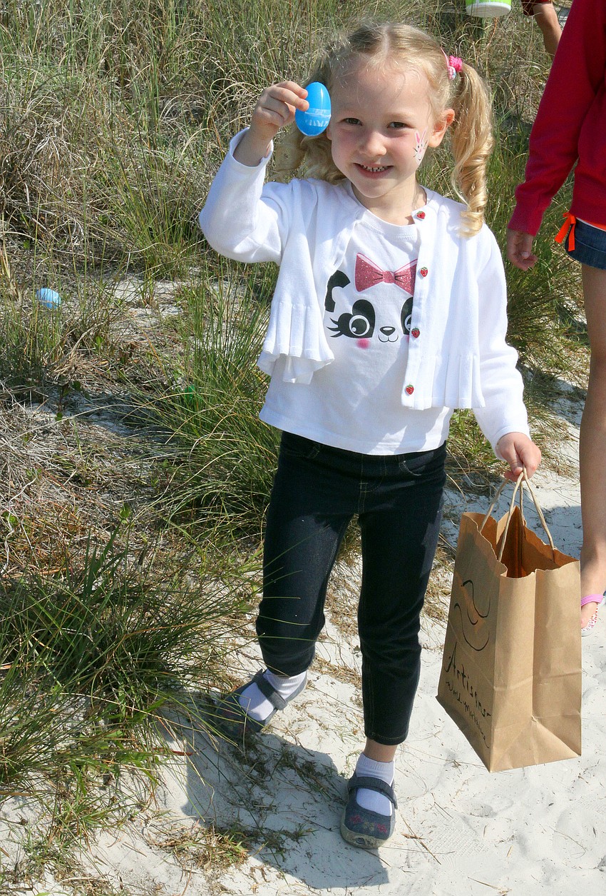 Aleysa Lange, 4, shows off one of the eggs she found on the beach.