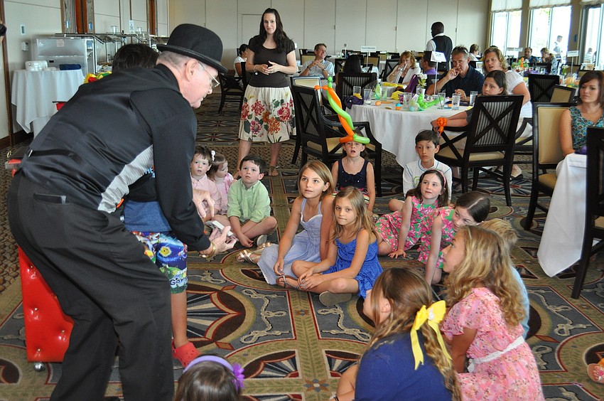 Magician Stevie Dee performs for the children