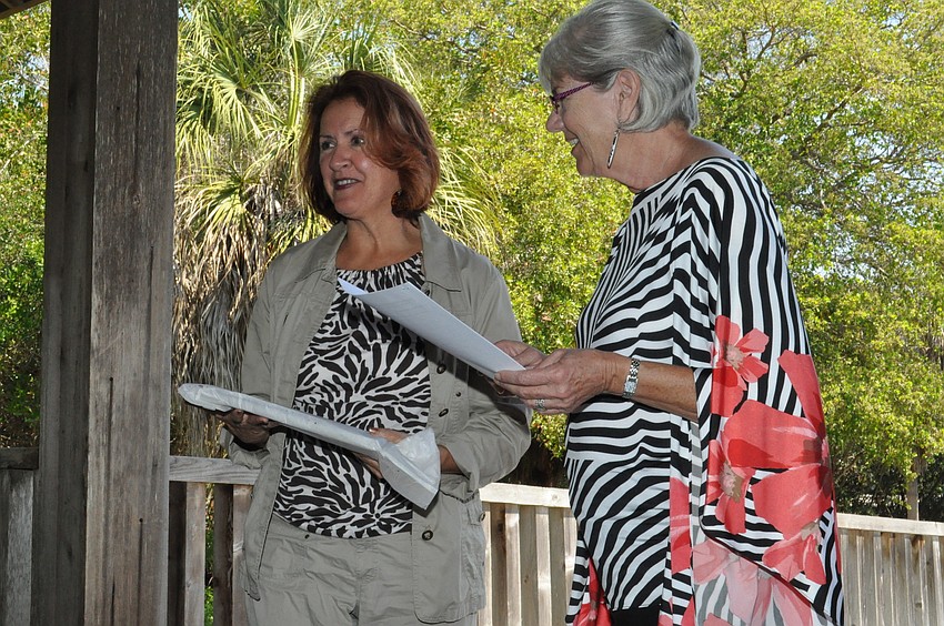 Judy Williams gives a thank you gift to Gail Condrick for participating in the Home and Garden Tour