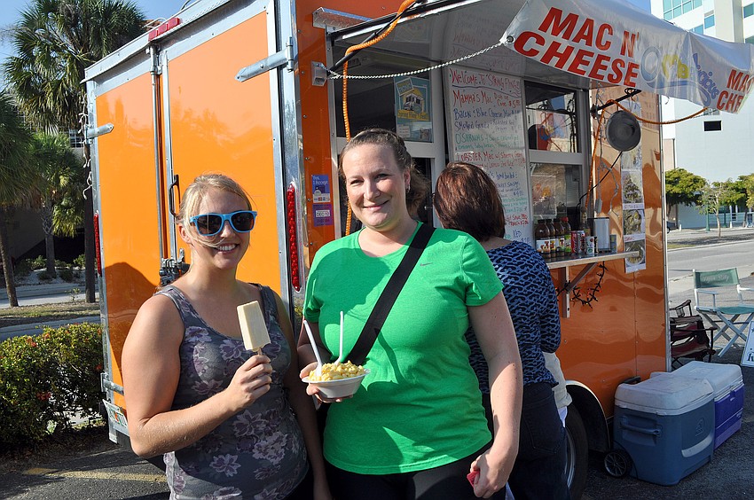 Katelyn Monroe and Drew Grissell have fun trying different treats from the food trucks at Ringling Picnic during Spring Fling.