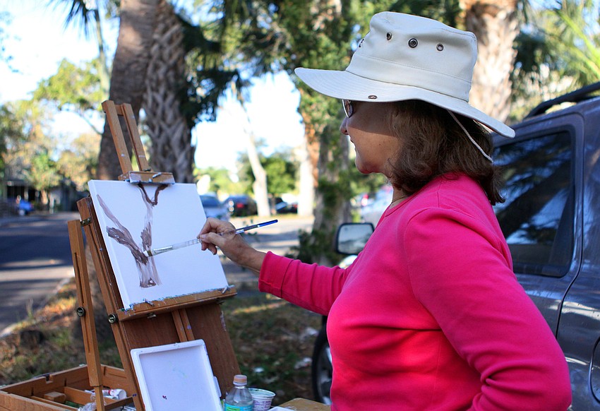 Carmen Letelier works on painting a tree, Thursday, Jan. 12, at Towles Court along with the other Plein Air Sun Coast artists.