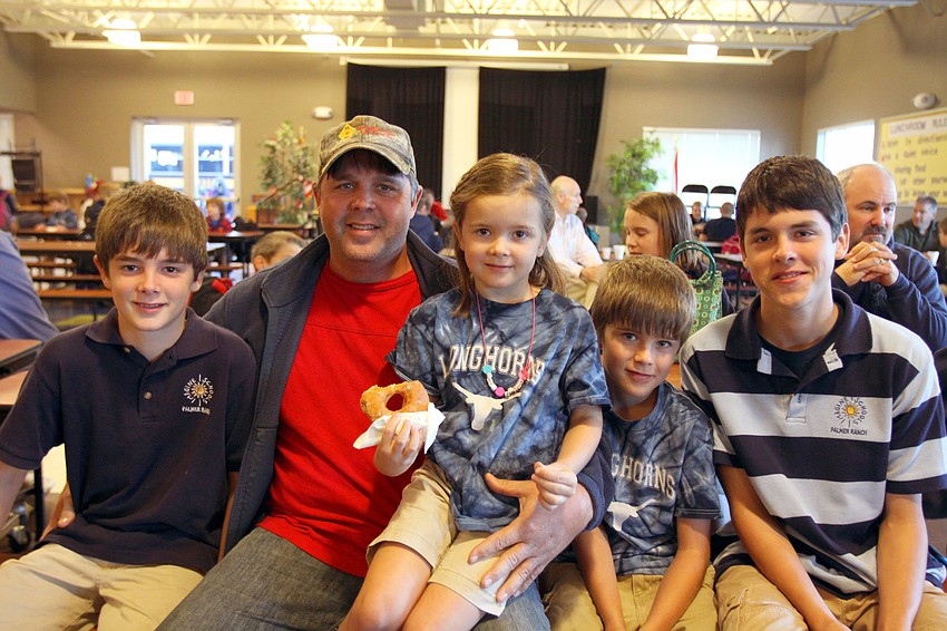 Jaron, 12, Royce, Marissa, 6, Carson, 8, and Brandon, 14, Miller enjoy having donuts together, Friday, Jan. 13, at Imagine School's 