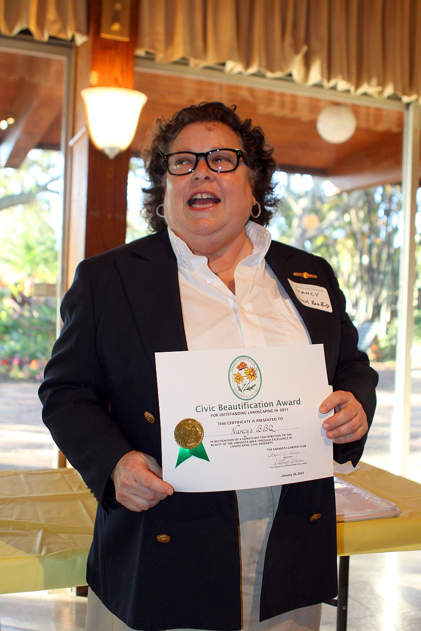 Nancy Krohngold speaks to the crowd after being presented with her Civic Beautification Award for Nancy's BBQ, Friday, Jan. 20, at the Sarasota Garden Club.