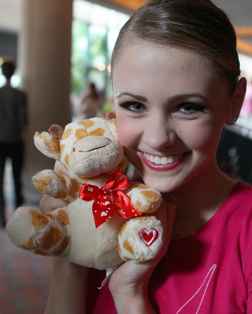 Kayleigh Likens shows off a small, stuffed giraffe given to her by her brother.