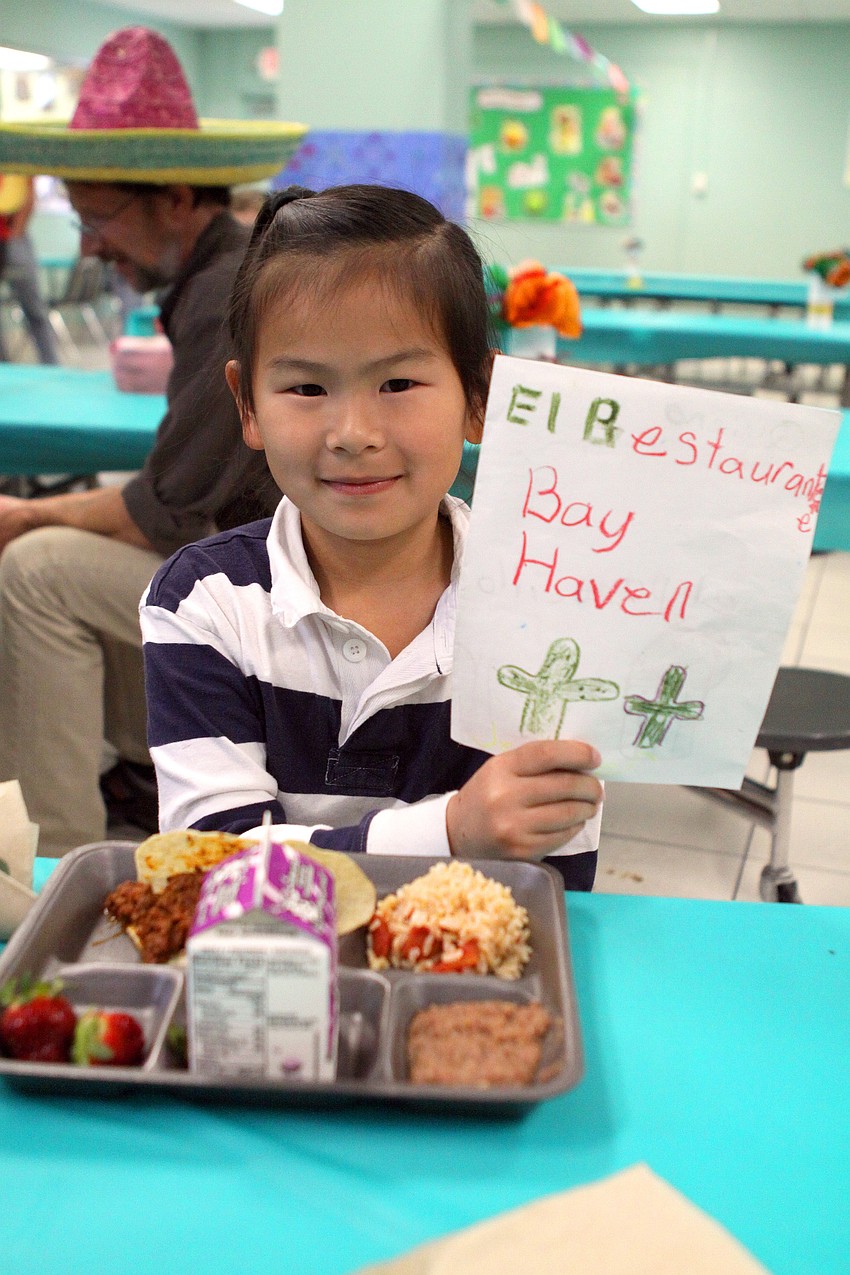 Jennifer Liu, 7, shows off her El Restaurante Bay Haven menu.