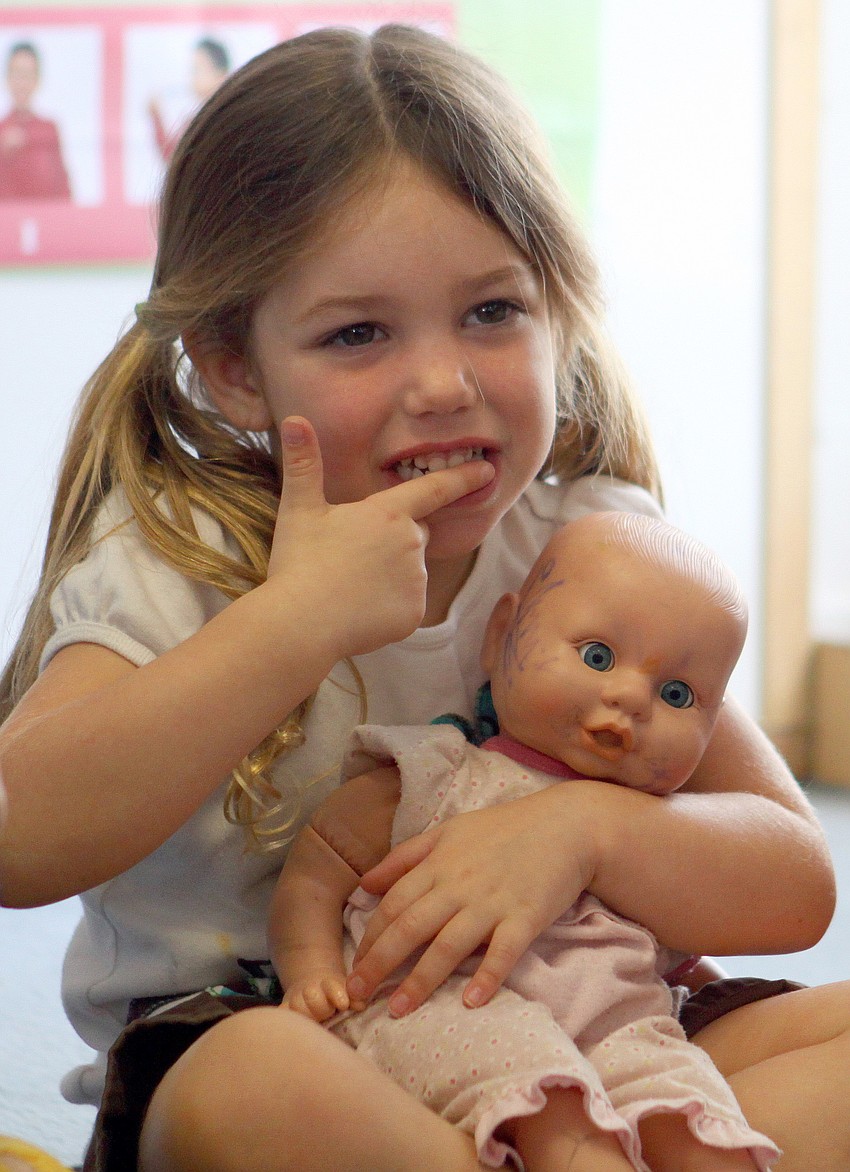Makala Milburn, 3, brushes her teeth during the 