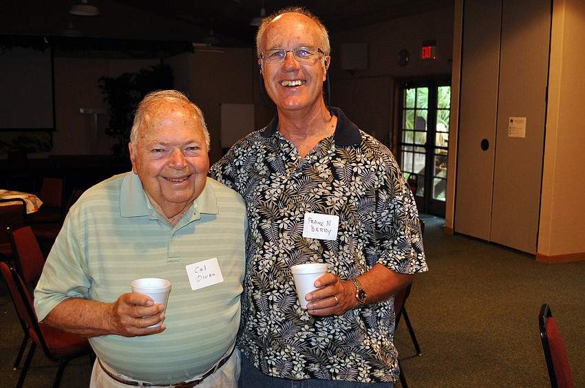 Cal Owen and Frank N. Berry pose together with their coffees, Tuesday, Feb. 28, inside the Fellowship Hall at Siesta Key Chapel.