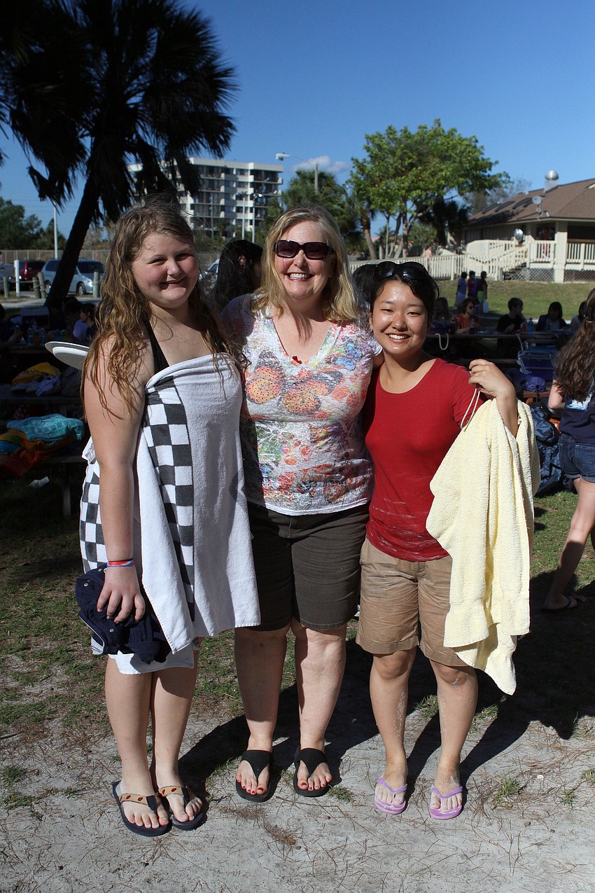 Jana Miracle poses with her daughter, Gracie Miracle, 15, and Eri Morikawa, 20, after Gracie and Eri took a dip in the Gulf of Mexico.