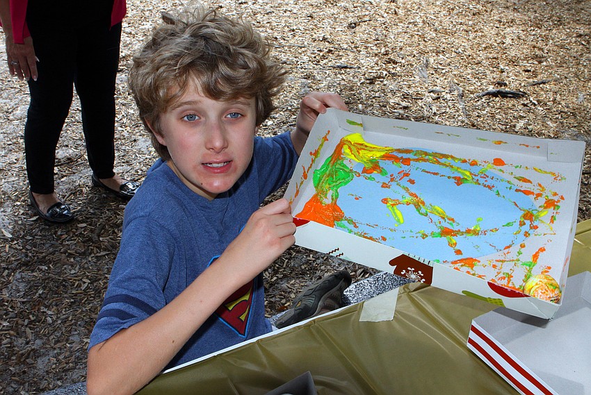 Kameron Helmick, 10, has fun doing a craft at the Face Autism Egg Hunt, Saturday, March 31, at Ashton Elementary.