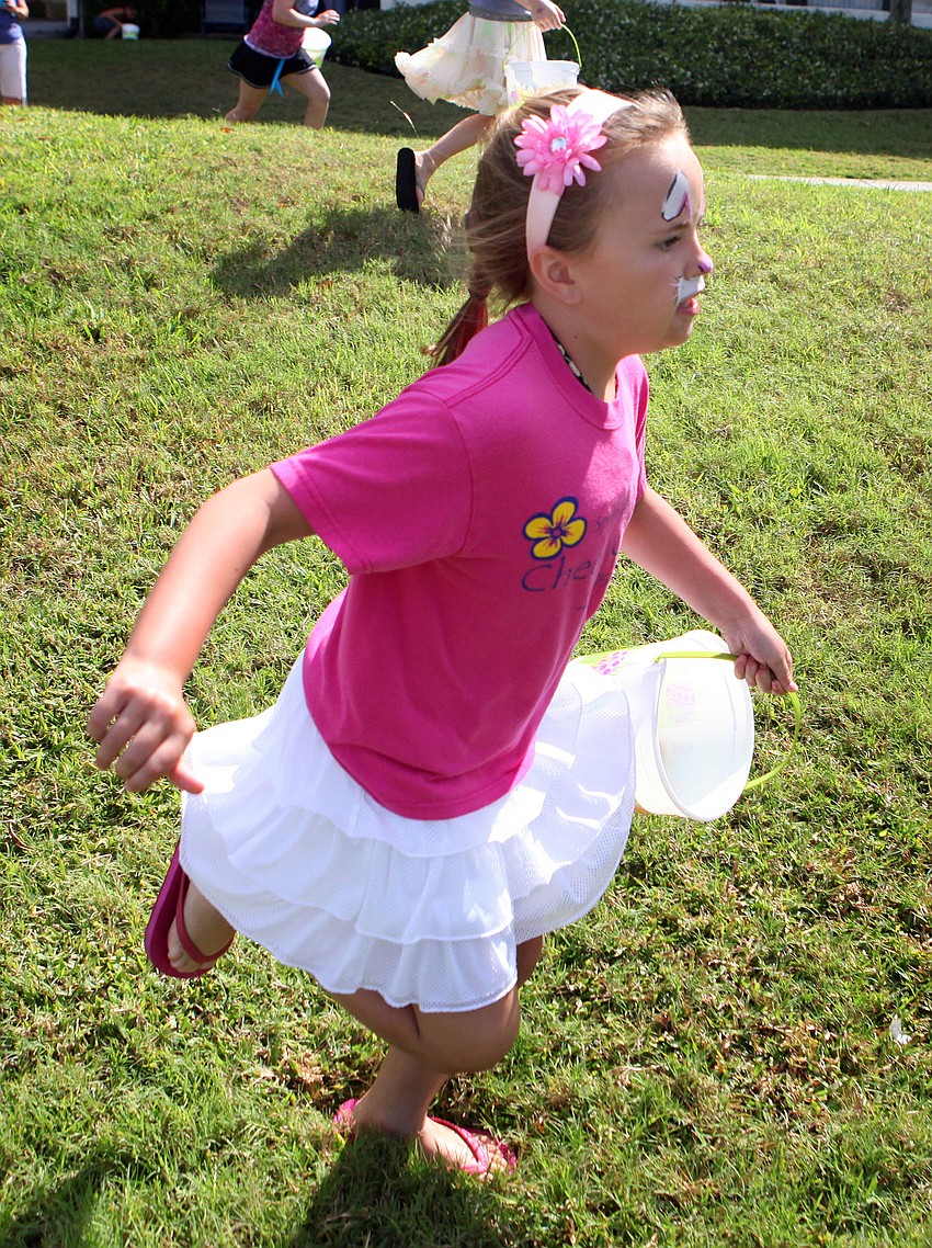 Holly Stachler, 8, runs as quickly as she can in hopes of gathering as many eggs as possible.