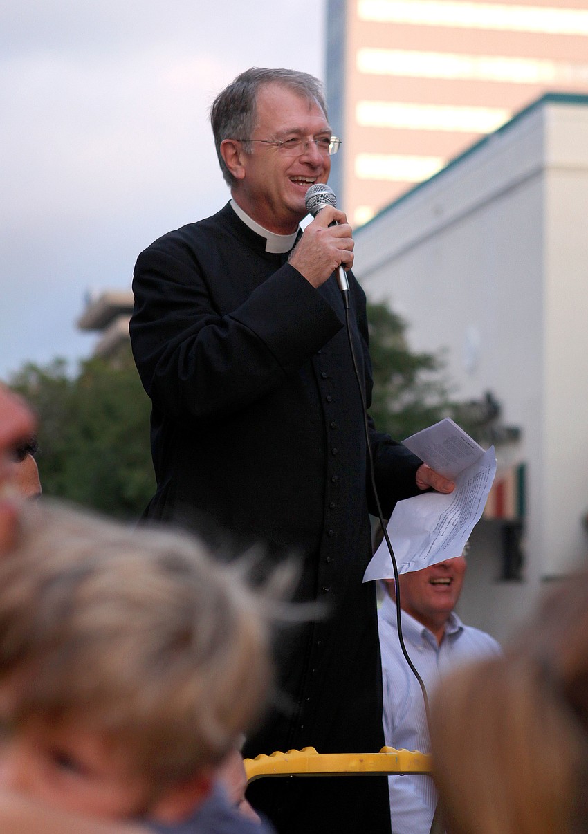 Fr. Fred Robinson called the crowd to order and welcomed them to the 16th Annual Good Friday Stations of the Cross walk, Friday, April 6, down Main Street.