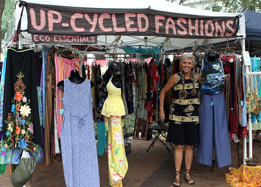 Jill Evans poses outside of her booth for Up-Cycled Fashions.