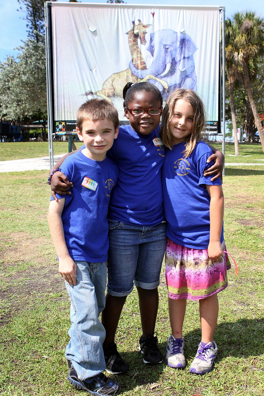 Phillippi Elementary students Tobias Lavalle, 7, London Harris, 7, and Mercedes Wasil, 7, pose in front of one of their favorite pieces, â€œExpectingâ€.