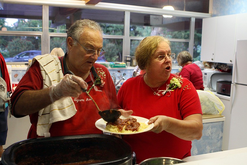 Norman Rao and Penny Thomas serve up some spaghetti in the kitchen, Saturday, Jan. 7 at the Sarasota Garden Club.
