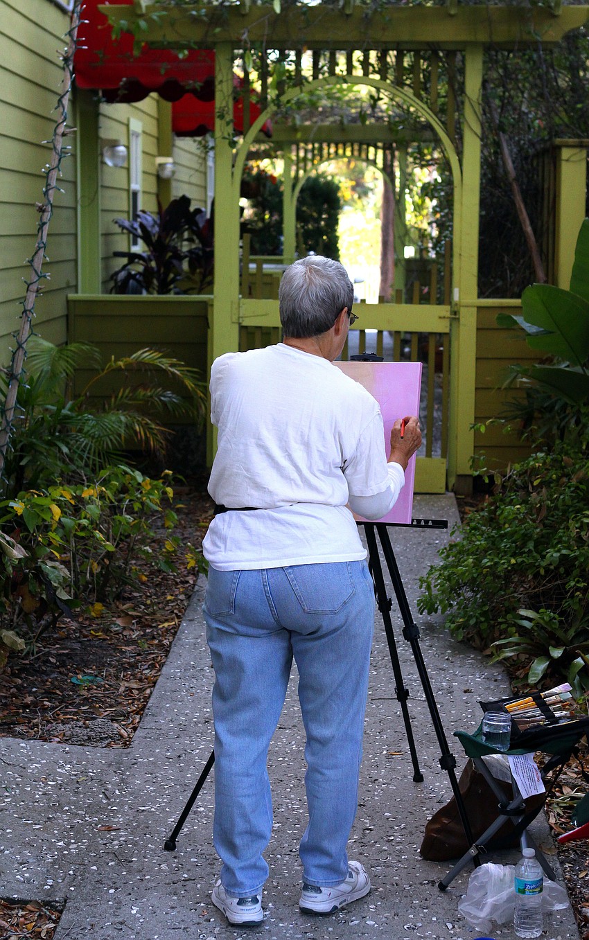 Betty Liner paints Thursday, Jan. 12, in Towles Court with the rest of the Plein Air Sun Coast artists.