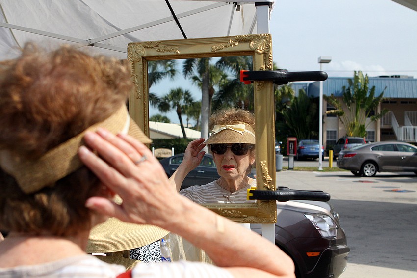 Marjorie Rosenthal tries on one of Petraâ€™s Hats.