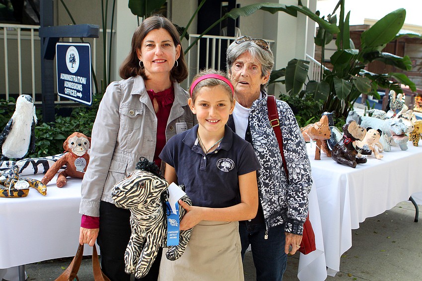 Elle LaClair, 4th grade, shows off her art project and poses with Nancy Stults and Rita LaClair, Friday, Feb. 10, during Grandfriends Day at Out-of-Door Academy.
